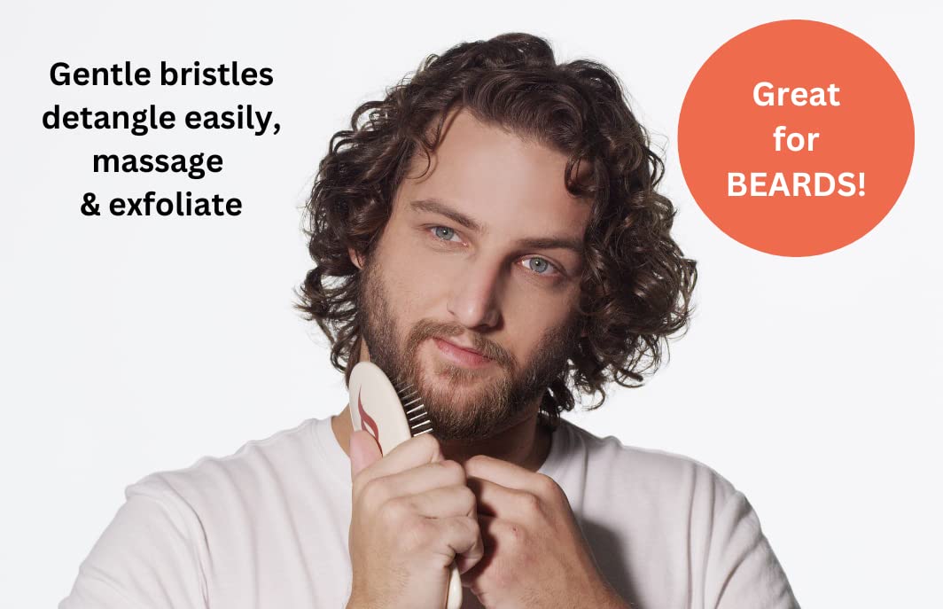 Happy man brushing beard to groom, massage and exfoliate with Untangle brush.