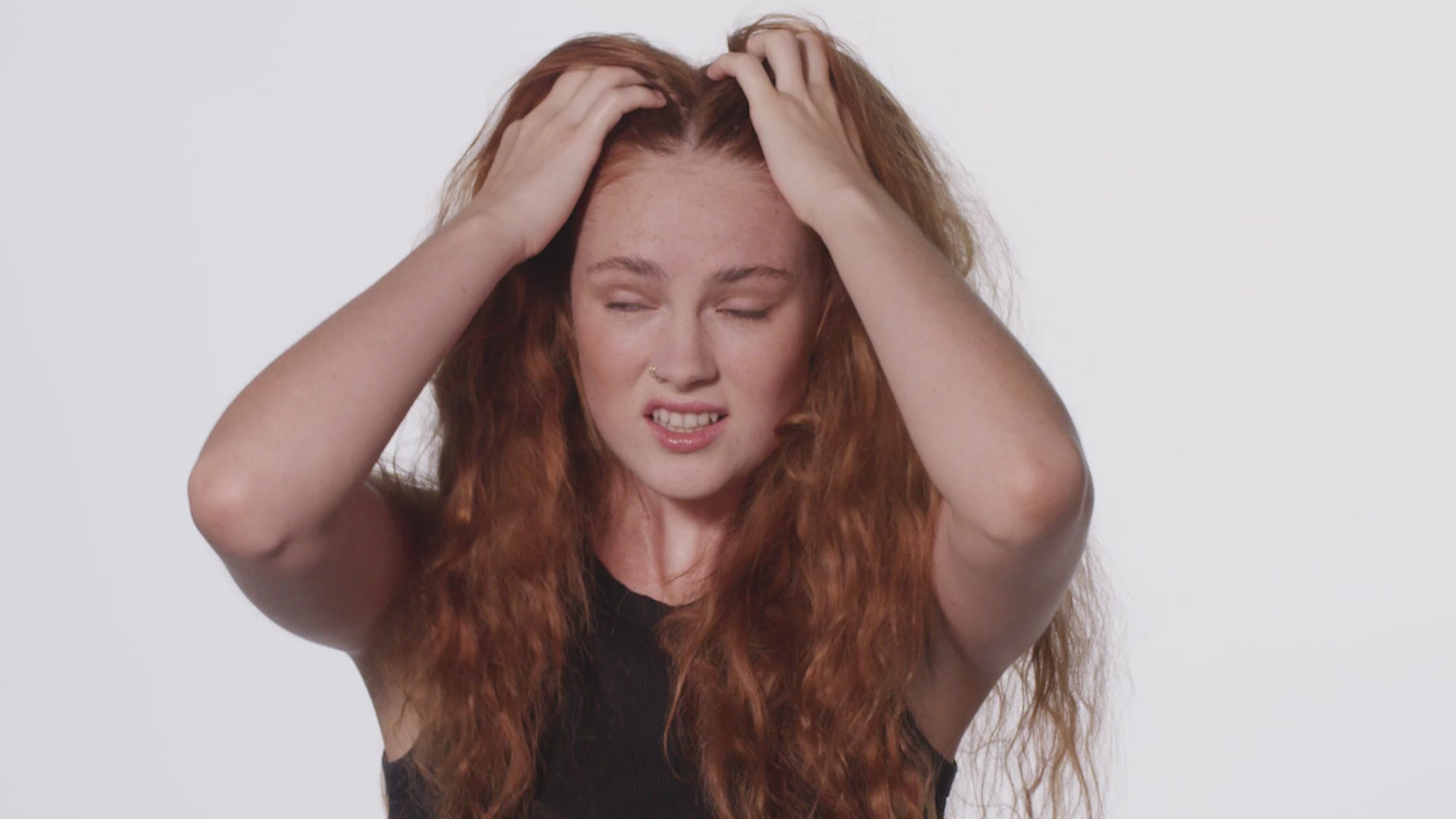 Woman with long red curly hair upset how tangled her hair is. Woman becomes very surprised at the ease of which the Sheila Stotts Untangle brush glides through her hair. She massages her scalp with the Untangle brush with a look of bliss. Video ends with woman extremely happy with her freshly styled long curly red hair.